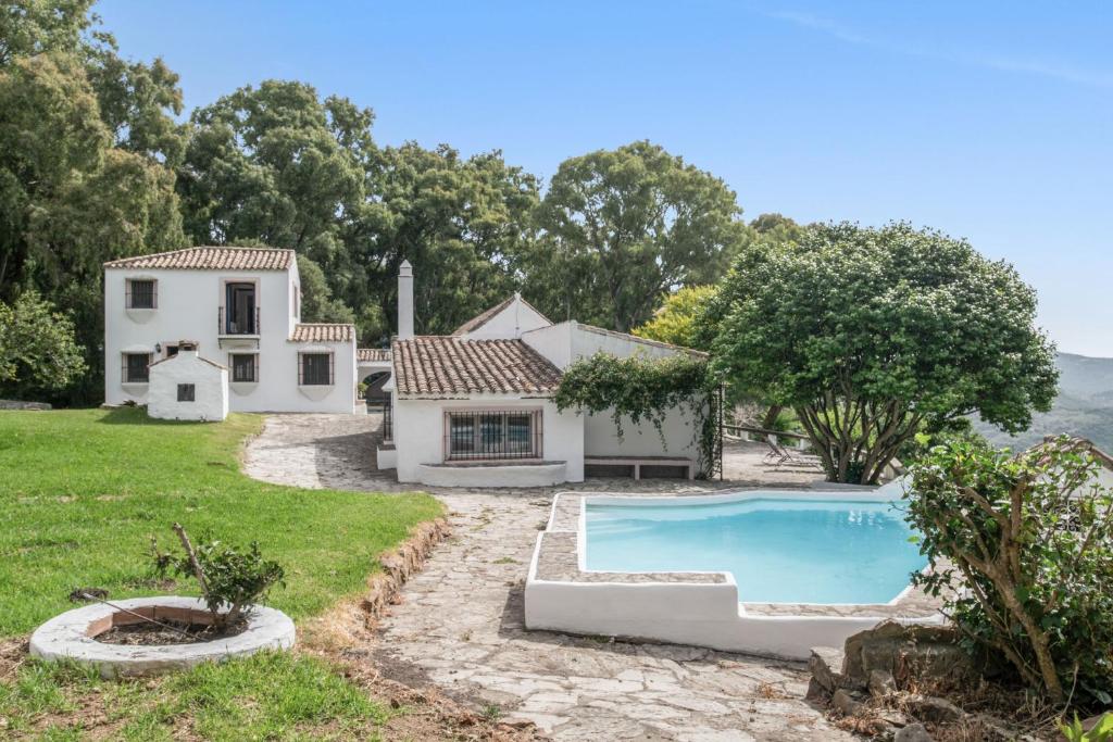 an exterior view of a house with a swimming pool at Cortijo Cantarranas - Tarifa in Tarifa