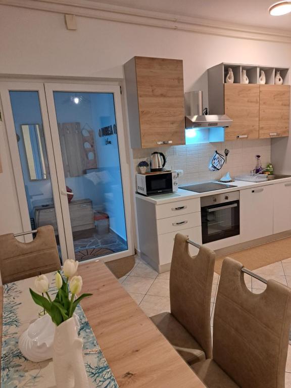 a kitchen and dining room with a table and chairs at Dorea in Jagodje