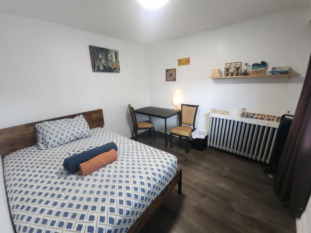 a bedroom with a bed and a table with a radiator at Affordable Quiet Private Room - 10-min Walk to Subway in Toronto