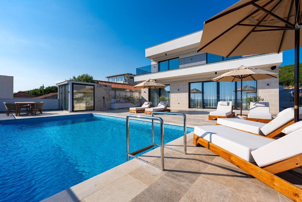 a villa with a swimming pool and a house at Krimovica Villas in Budva