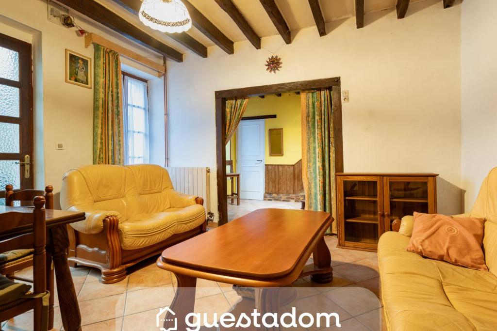 a living room with a couch and a table at On The Rocks - Alpes Mancelles - Jardin in Sillé-le-Guillaume