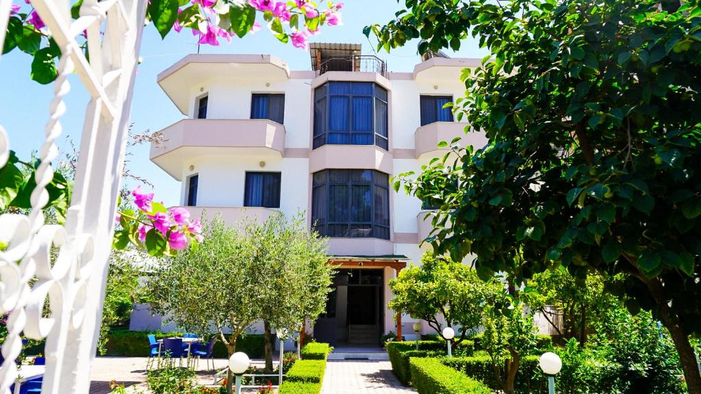 a building with trees in front of it at Vila Flamuri in Golem