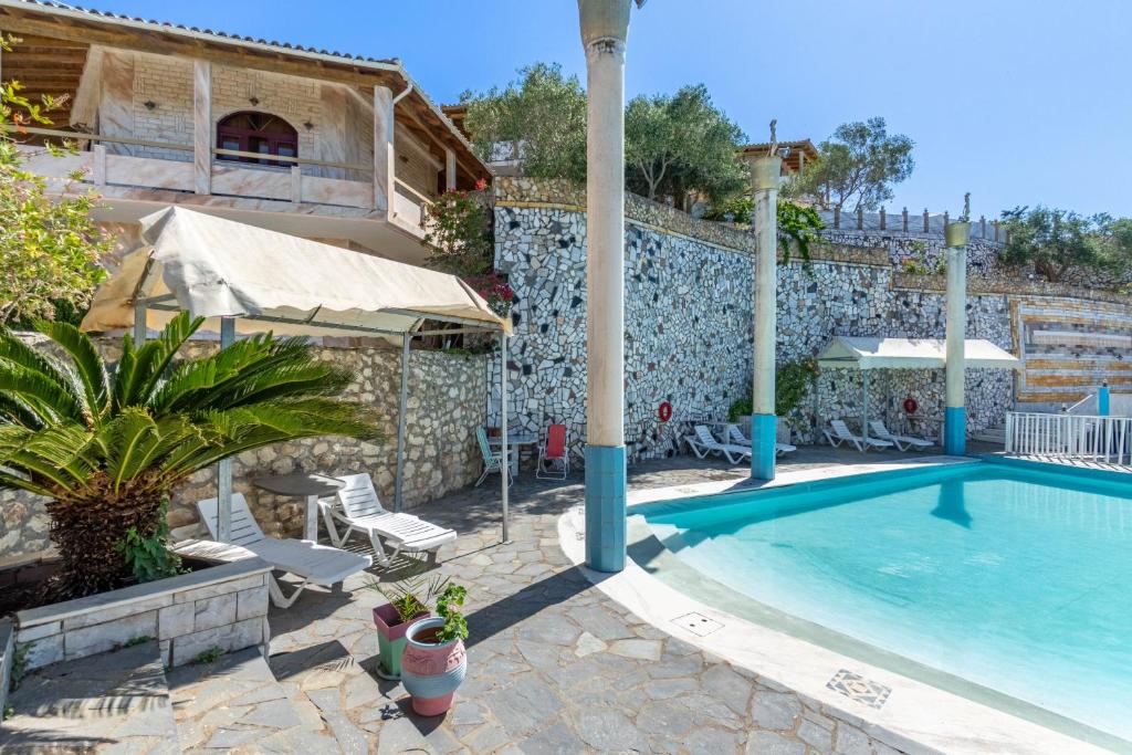 a villa with a swimming pool and a building at Paco's Resort Standard Studio 1 in Oziás