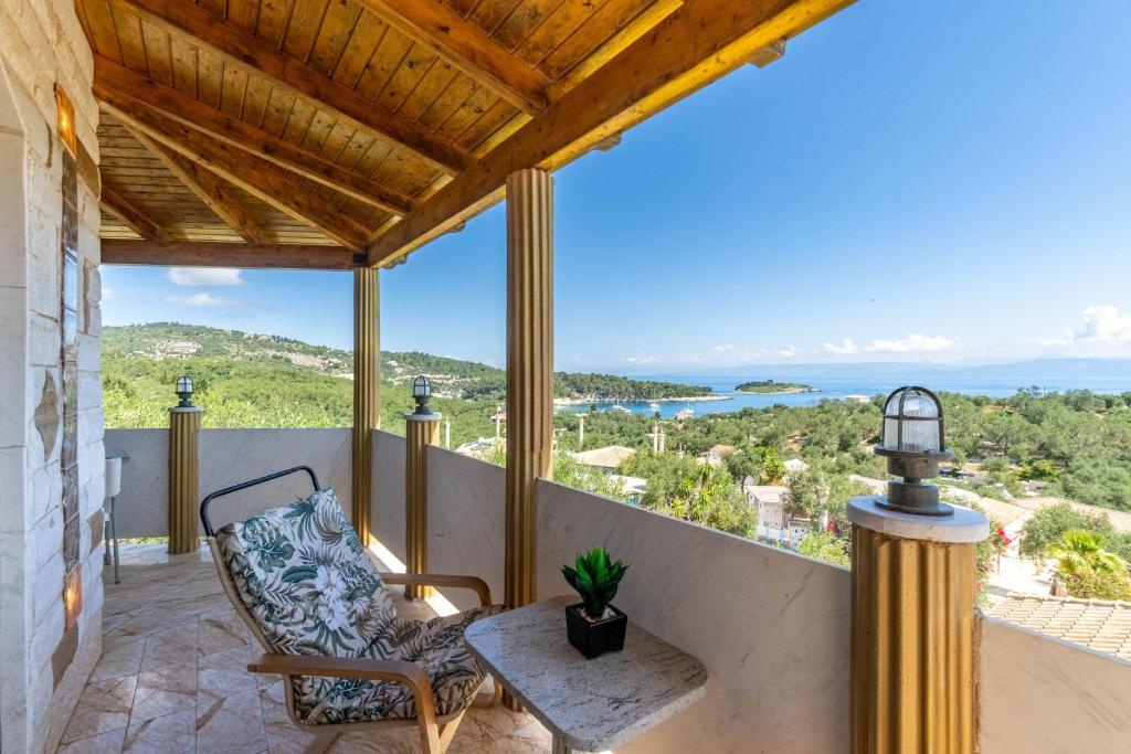 an outdoor balcony with a chair and a table at Paco's Resort Luxury Villa 19 in Oziás