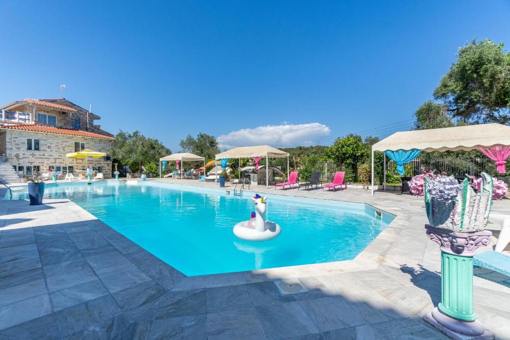 a swimming pool with a woman in a ball in the middle at Paco's Resort Standard Studio 2 in Oziás
