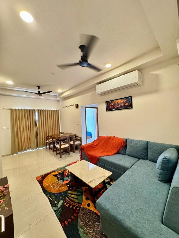 a living room with a couch and a table at Sky height 2BHK in GIFT CITY in Gandhinagar
