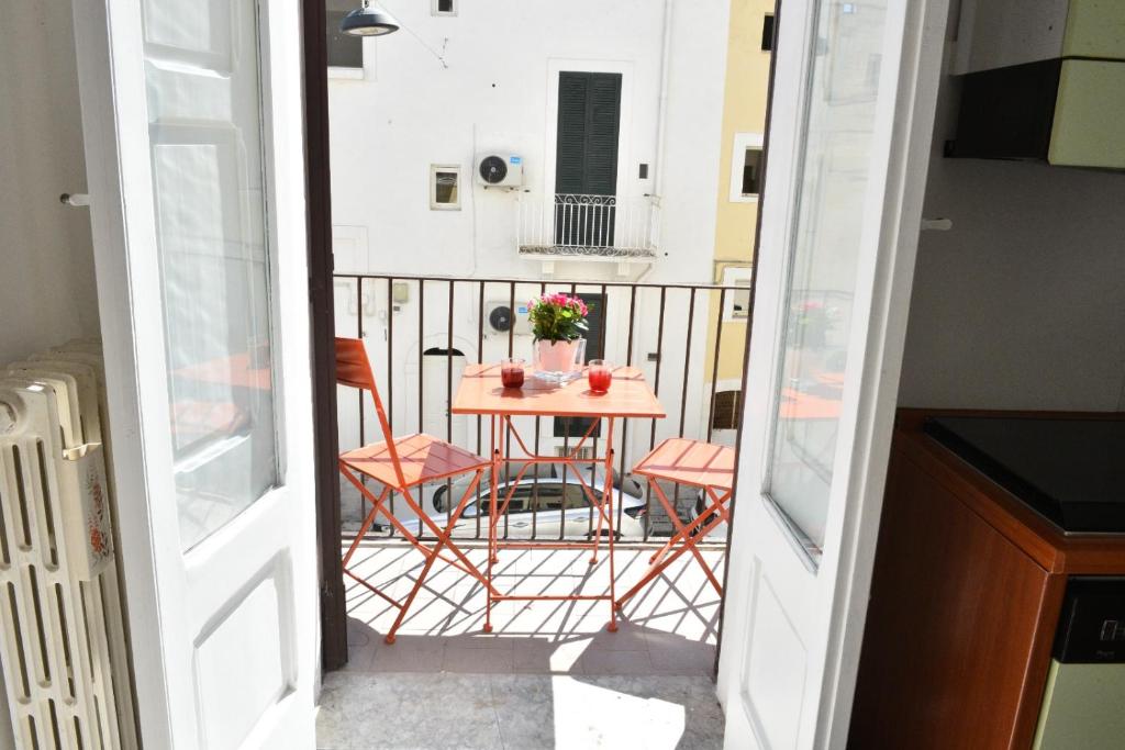 a small balcony with a table and chairs on it at Donna Lina Home- Enjoy Apulia in Monopoli