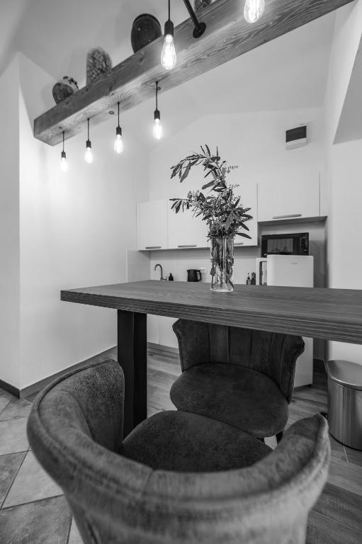 a table in a kitchen with a vase of flowers at Studio apartma Kamin in Nova Vas