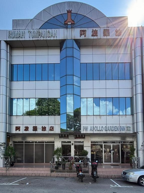 a building with motorcycles parked in front of it at Wangsa Village Inn in Ulu Tiram