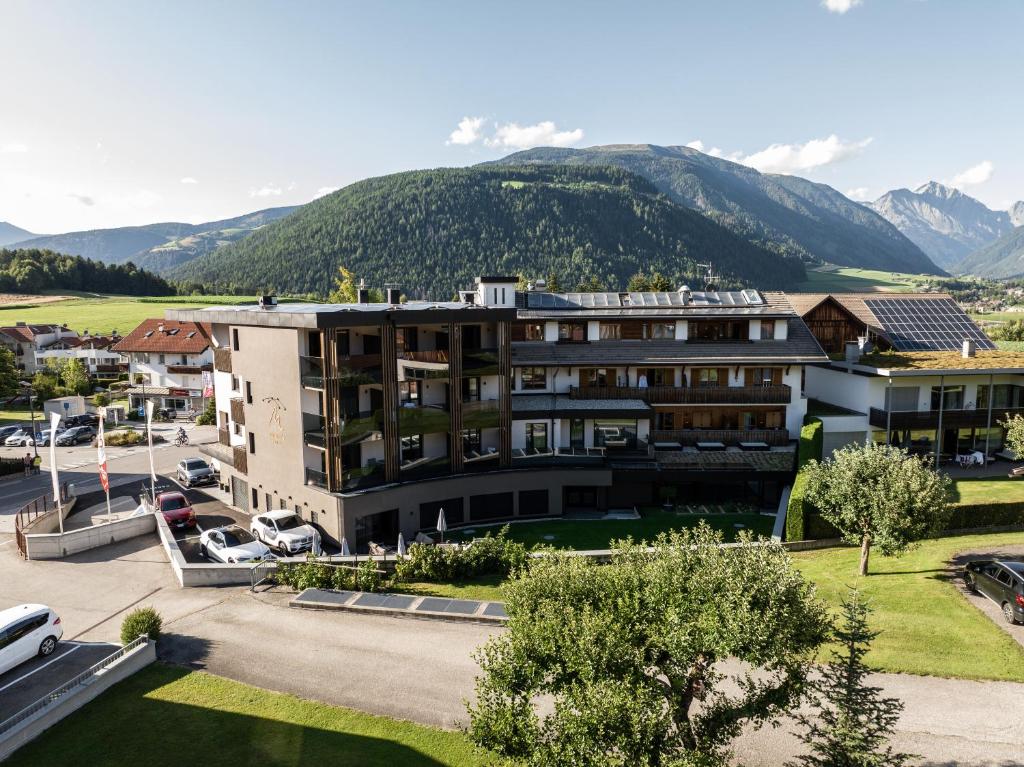 an aerial view of a hotel with mountains in the background at Moar's Hotel in Valdaora