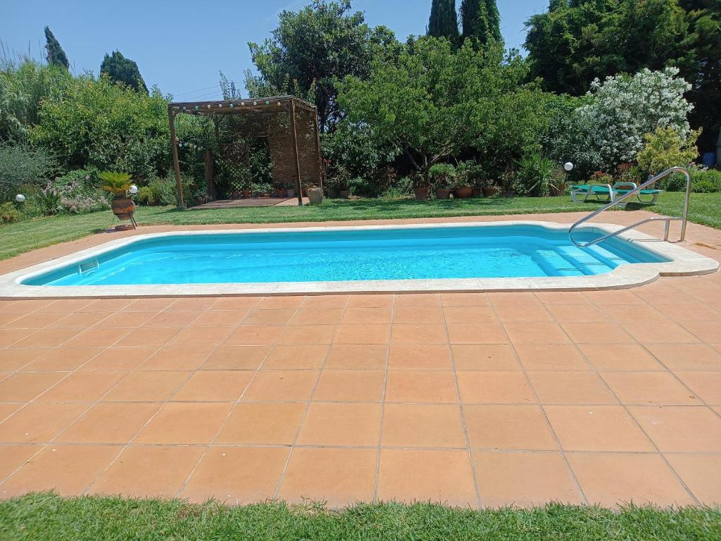 a swimming pool in a yard with afficient at TURISMe RURAL EMPORDA in Torroella de Montgrí