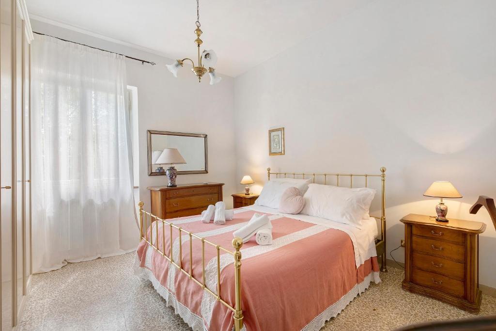 a bedroom with a large bed and a window at Casa Ortensia in Spoleto