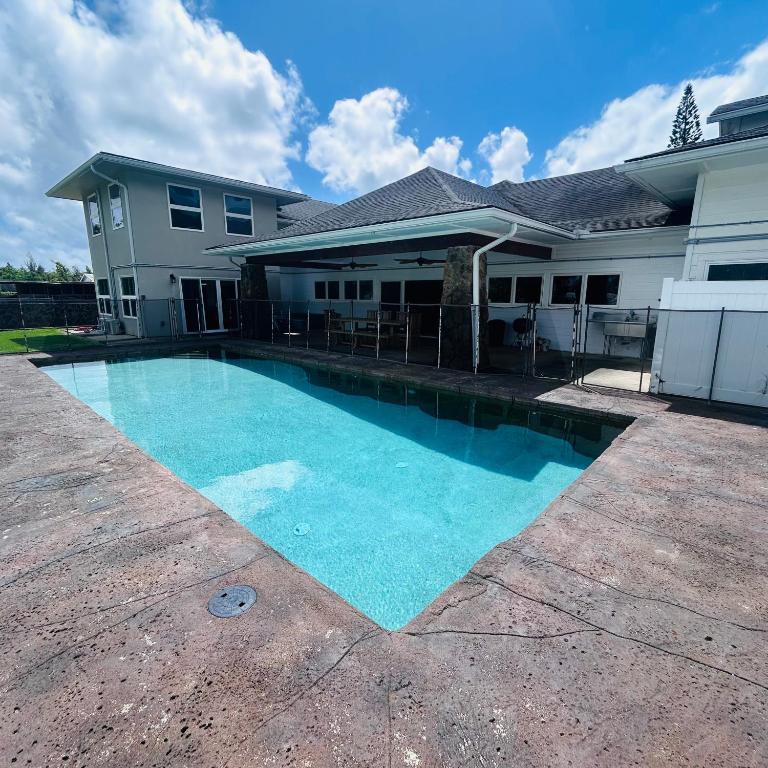 a swimming pool in front of a house at Hale Halai in Hauula