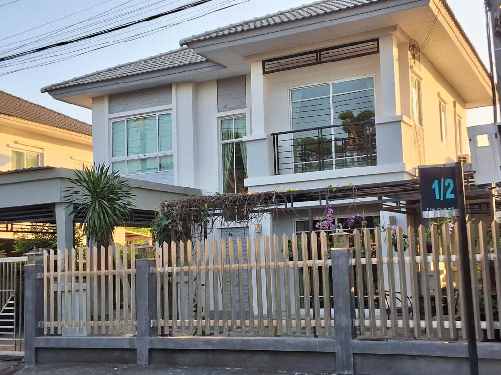 a house with a fence in front of it at The Plant Light Thiwanon in Lat Lum Kaeo