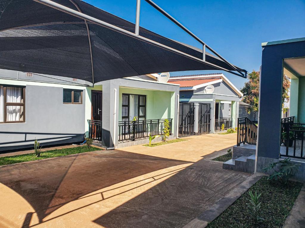a large black umbrella in front of a house at Area 46 BnB in Lilongwe