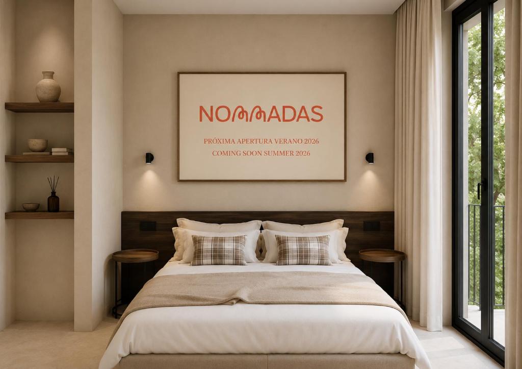a bedroom with a large bed with a picture on the wall at Nommadas Cotty - Only Adults in Denia