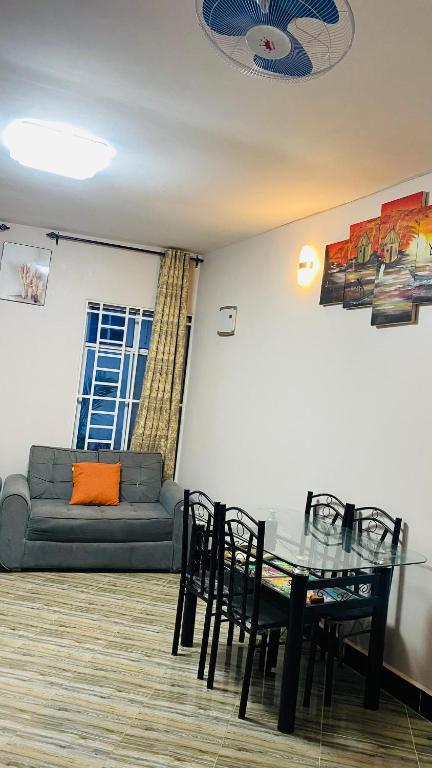 a living room with a glass table and a couch at Varine House in Dodoma