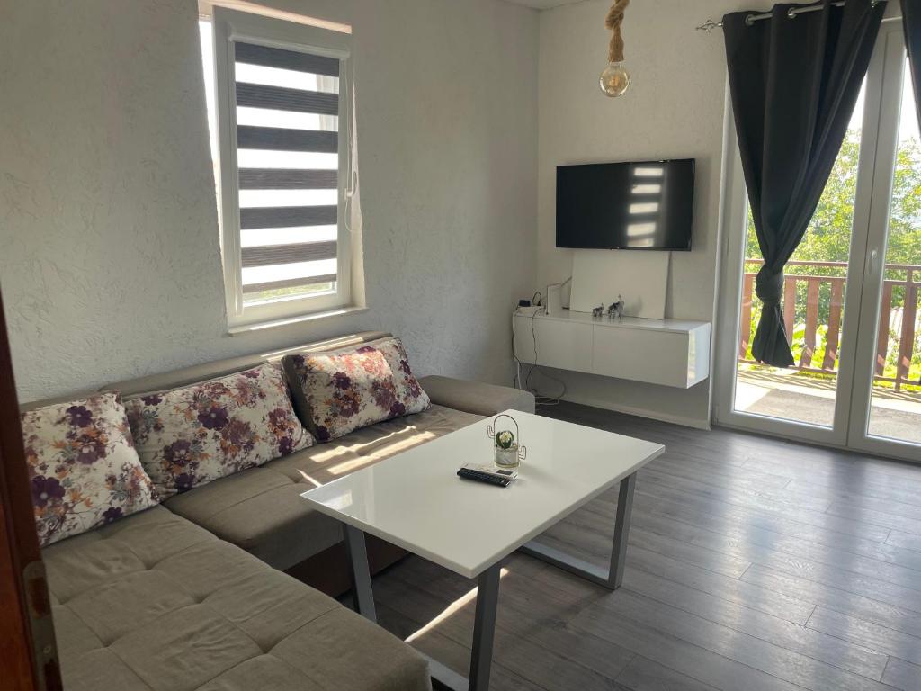 a living room with a couch and a table at Villa Apartments STEFAN - Ramne Ohrid in Ohrid