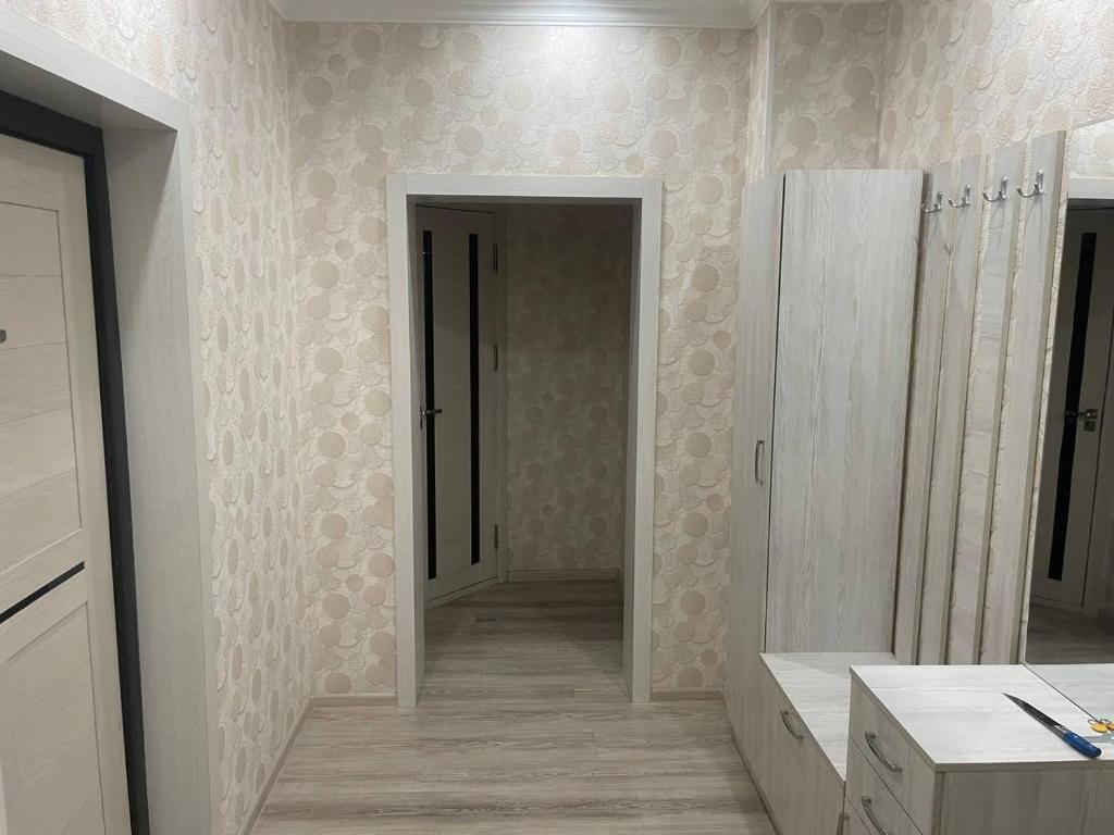 a bathroom with a sink and a mirror on the wall at Kvartira in Toshkent-Passajir Bekati