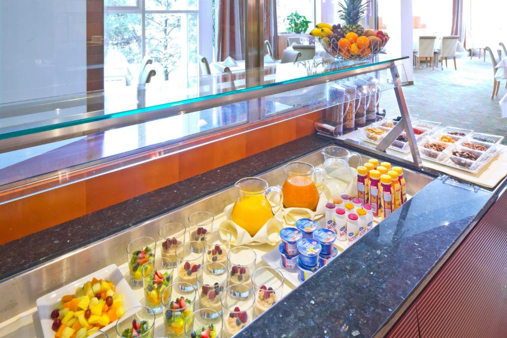 a buffet line with a variety of desserts and drinks at Hotel Penz West in Innsbruck