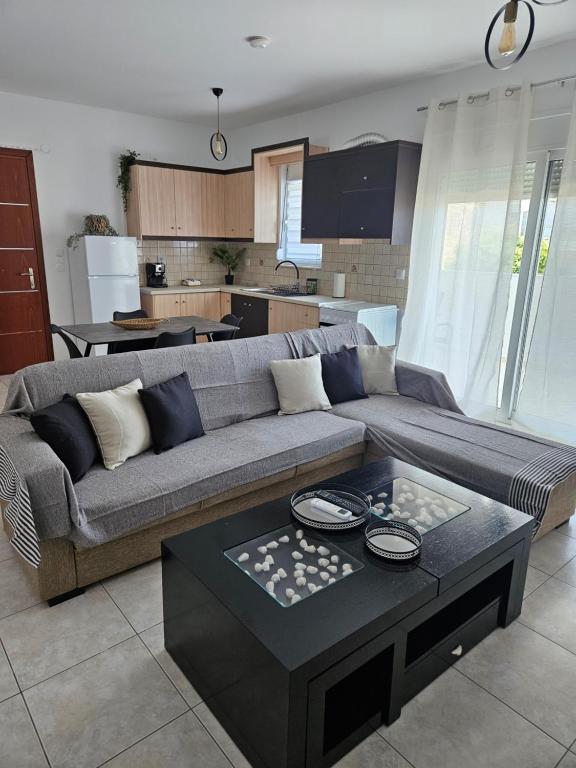 a living room with a couch and a table at Poppis Home in Ierapetra