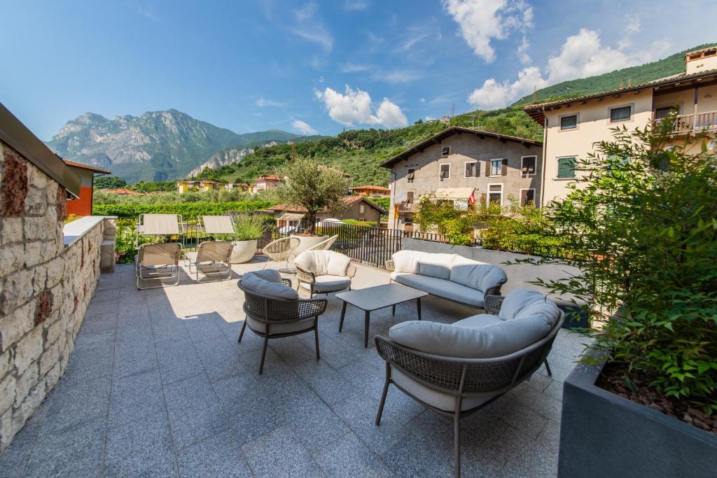 a patio with couches and chairs and a table at HB Boutique Apartment in Arco