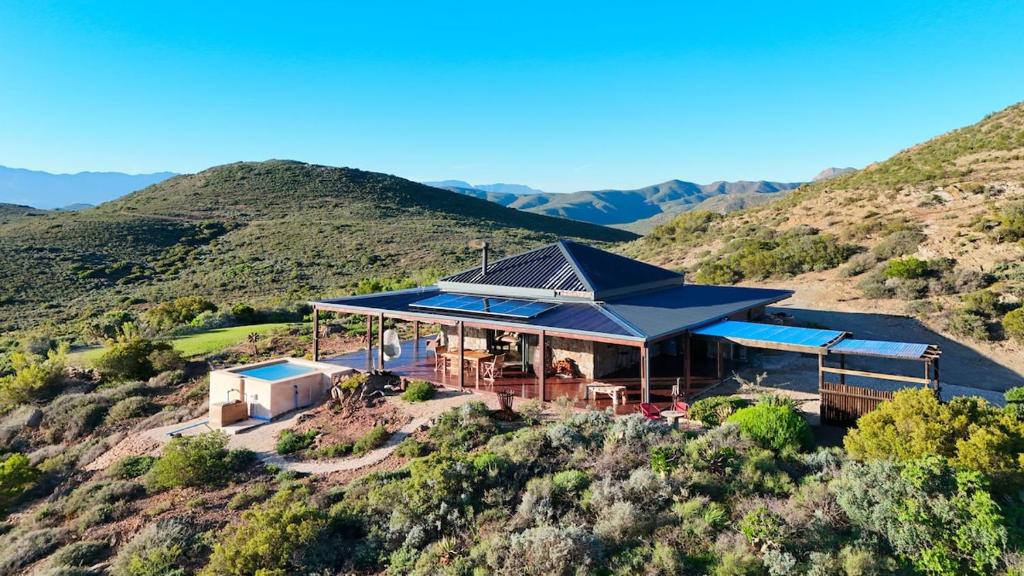 a house with a blue roof on top of a hill at Eldorado TopHouse in McGregor