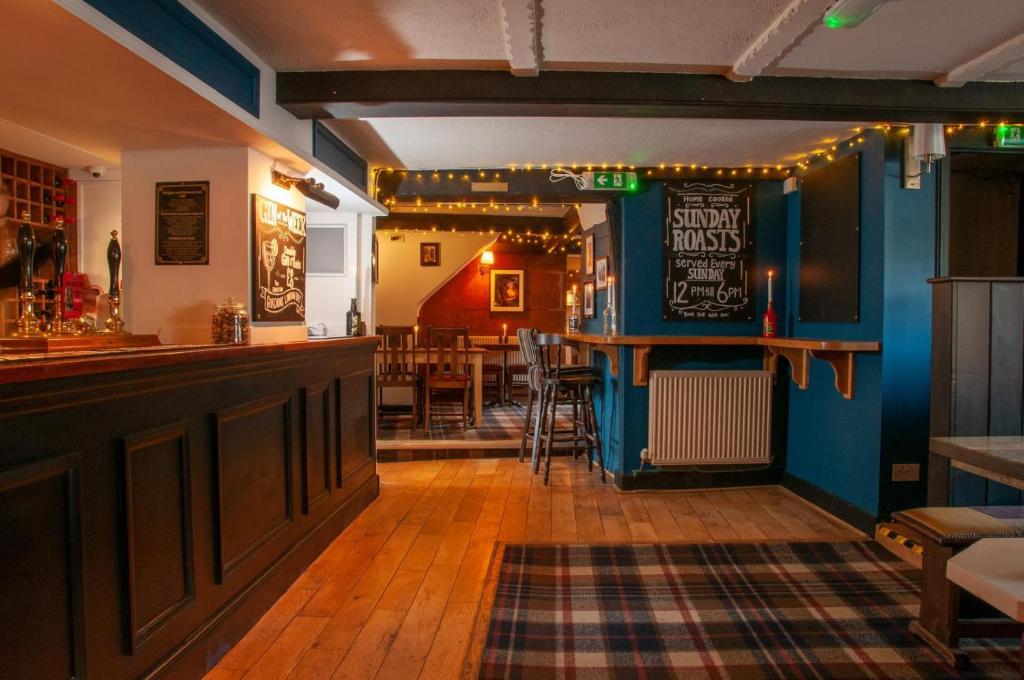 a bar in a pub with a table and chairs at Mason's Arms in Montacute