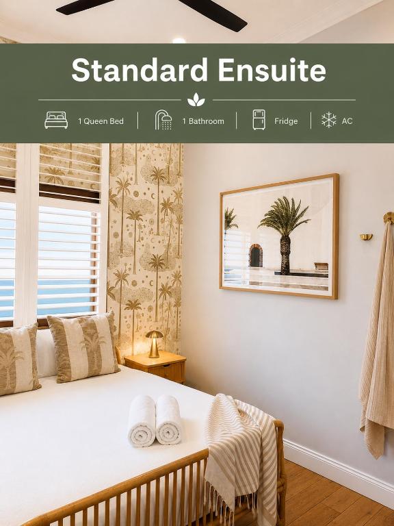 a bedroom with a bed with white towels on it at Bayhaven Lodge in Byron Bay