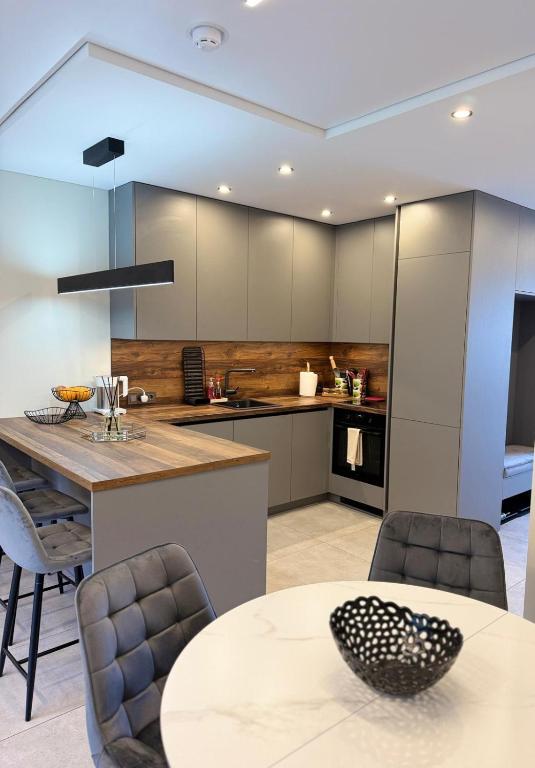 a kitchen with a table and a dining room at Riverside Cottage in Palanga