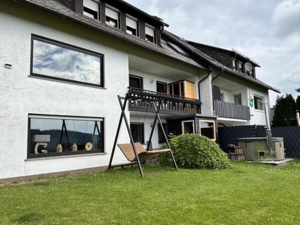 a house with a swing in the yard at Haus Aktiv Garten2 in Winterberg