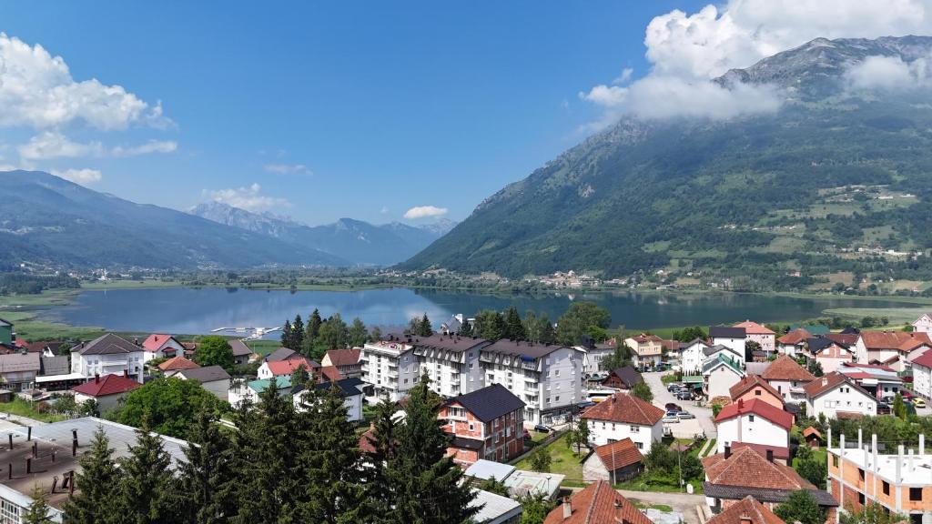 a town with a lake and mountains in the background at Blue Nest in Plav