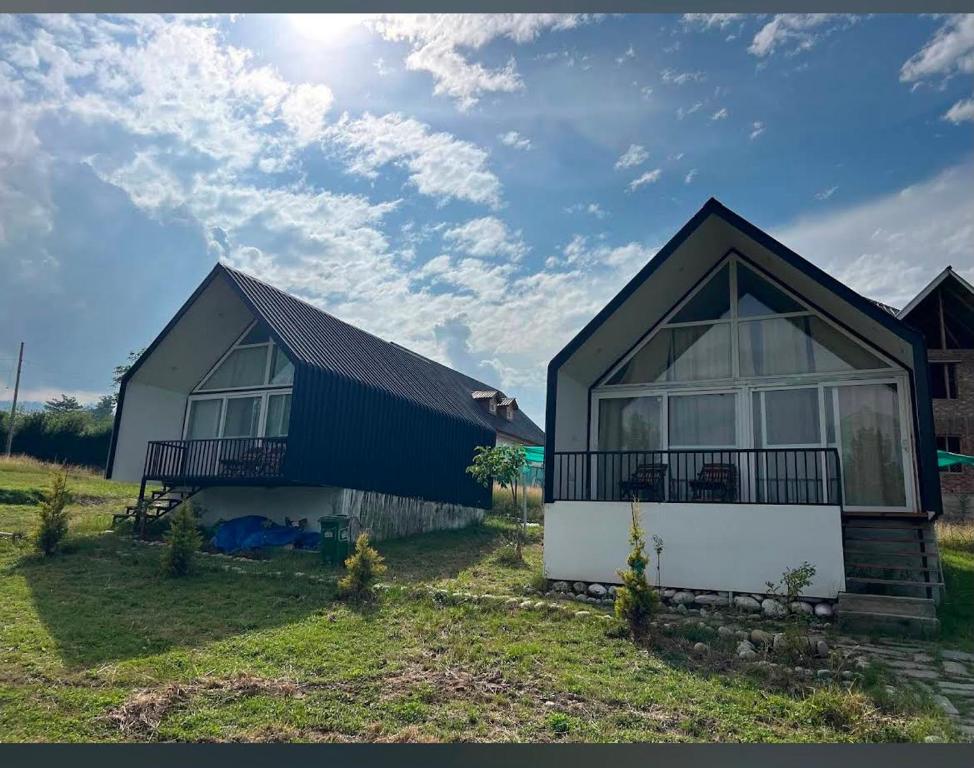 a home with a black and white house at Raiyar Resort doodhpathri in Rengazabal