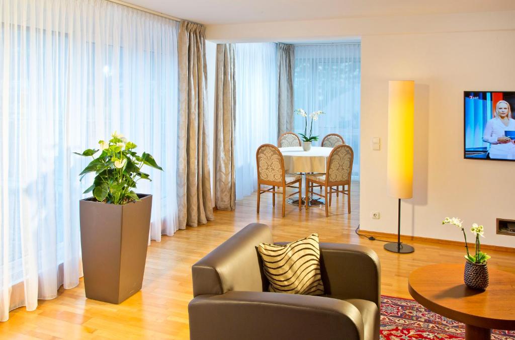 a living room with a couch and a table at Hotel Penz West in Innsbruck