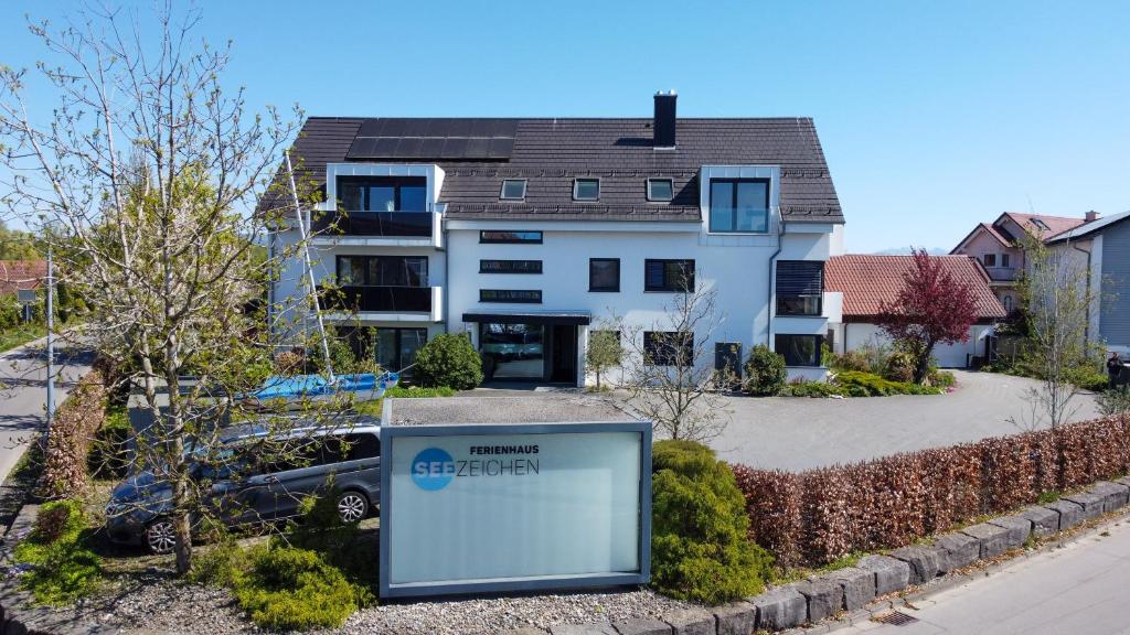 a house with a sign in front of it at Ferienhaus Seezeichen in Wasserburg