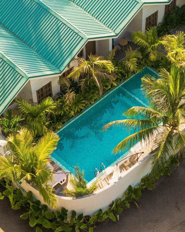 an overhead view of a resort pool with palm trees at Kondey Villas in Kondey