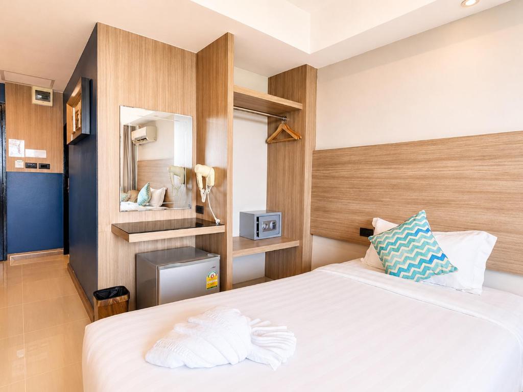 a bedroom with a large white bed in a room at Avana Laem Chabang Boutique Hotel in Ban Laem Chabang