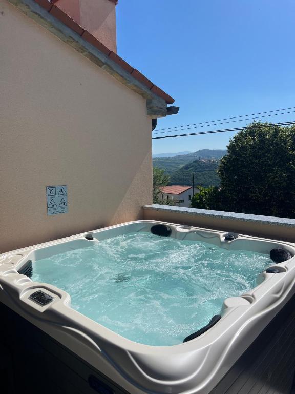 a hot tub on the balcony of a house at Apartment Panger in Izola