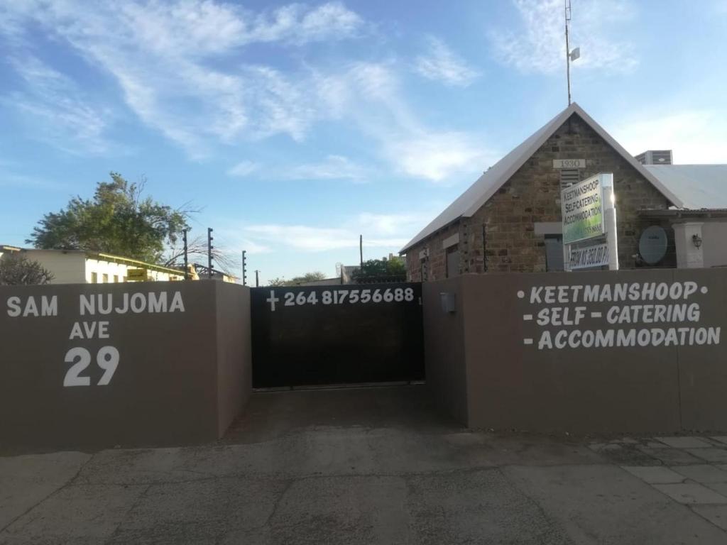 a building with a gate in front of a building at Keetmanshoop Self-catering in Keetmanshoop