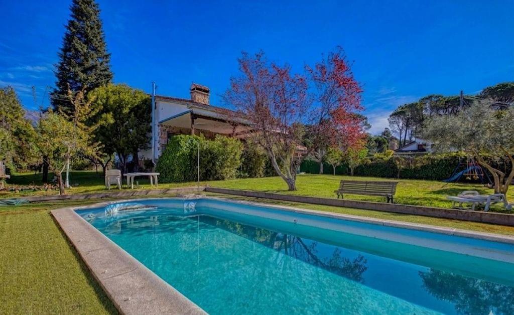 a swimming pool in front of a house at La Adrada Green Escape with pool in La Adrada