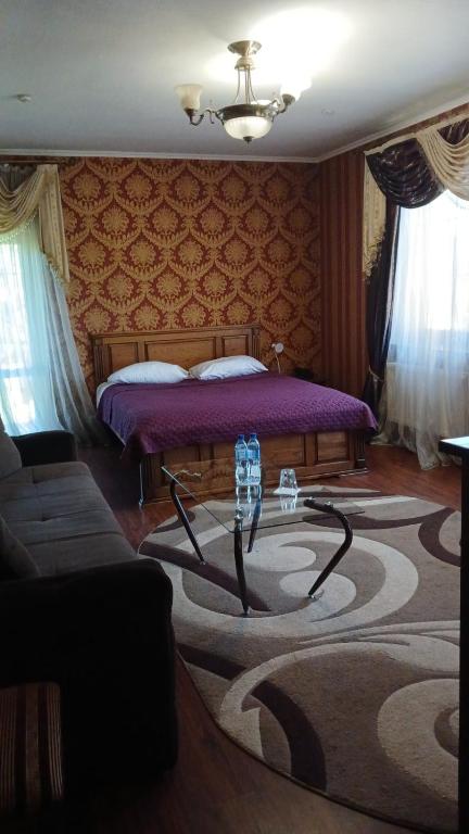a bedroom with a bed with a purple bedvisor at Casablanca Hotel in Kalush