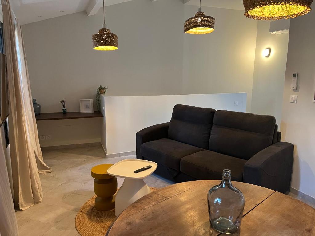a living room with a couch and a table at Chez Elsa et Camille in Aigues-Mortes