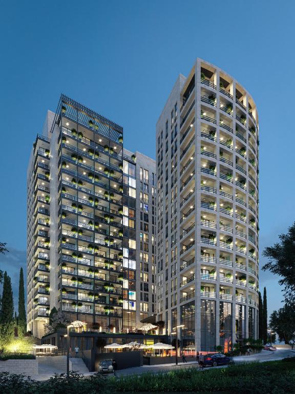 two tall buildings in a city at night at InterContinental Jerusalem by IHG in Jerusalem