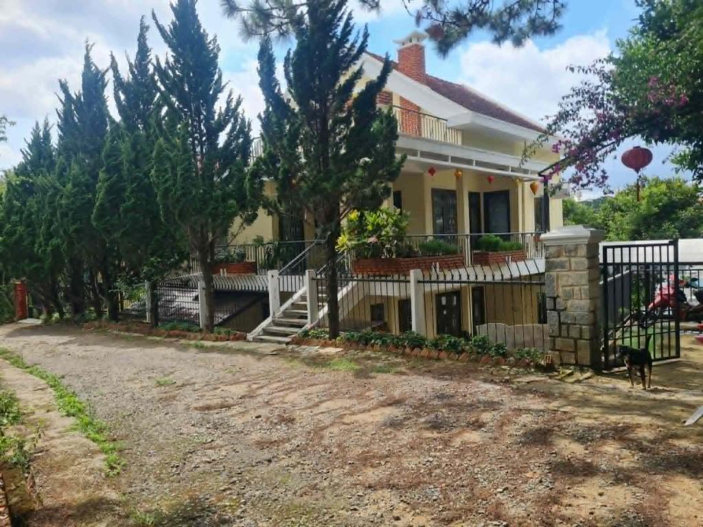 a house with a dog standing in front of it at SugarHouse in Da Thanh