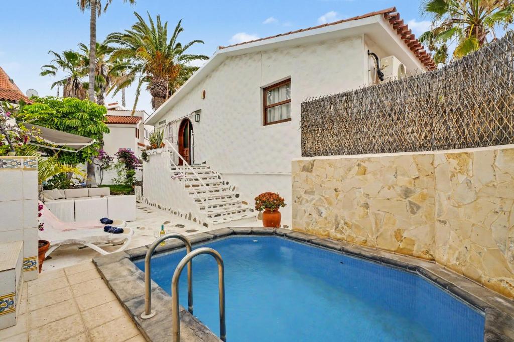 a swimming pool in front of a house at Private Pool And Ocean Views in Chayofa