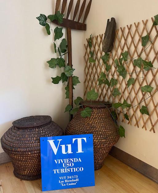 a sign sitting on the floor next to a plant at Las Riendas II La Casina in Muñeca