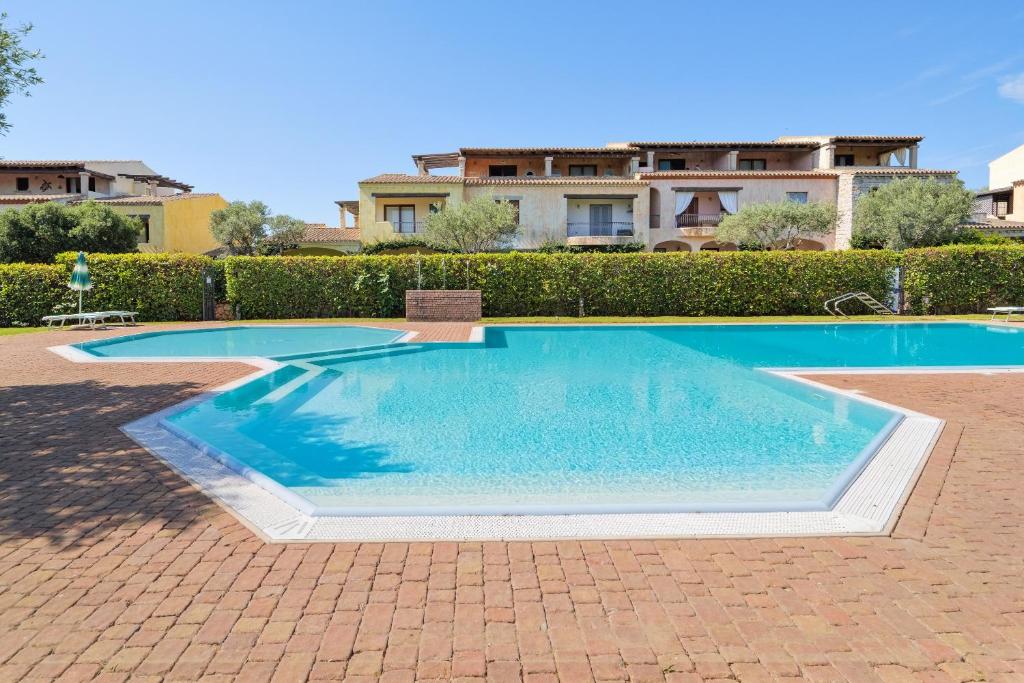 a swimming pool in front of a house at Il Balcone su Tavolara in Porto San Paolo