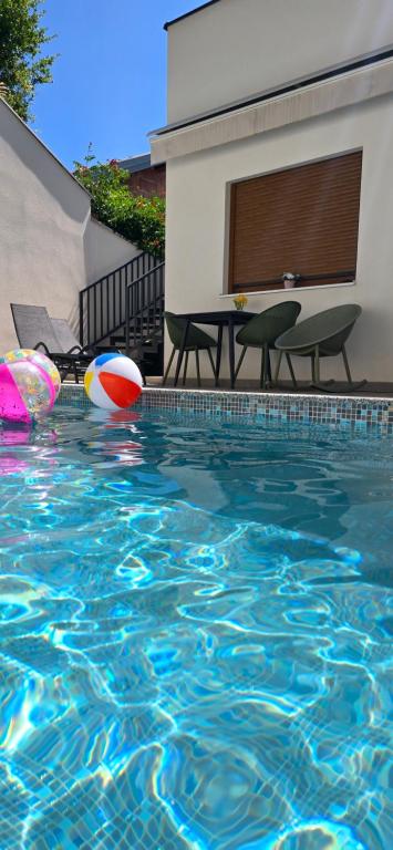 a swimming pool with a beach ball and a volley ball at Nerina Vila in Stolac