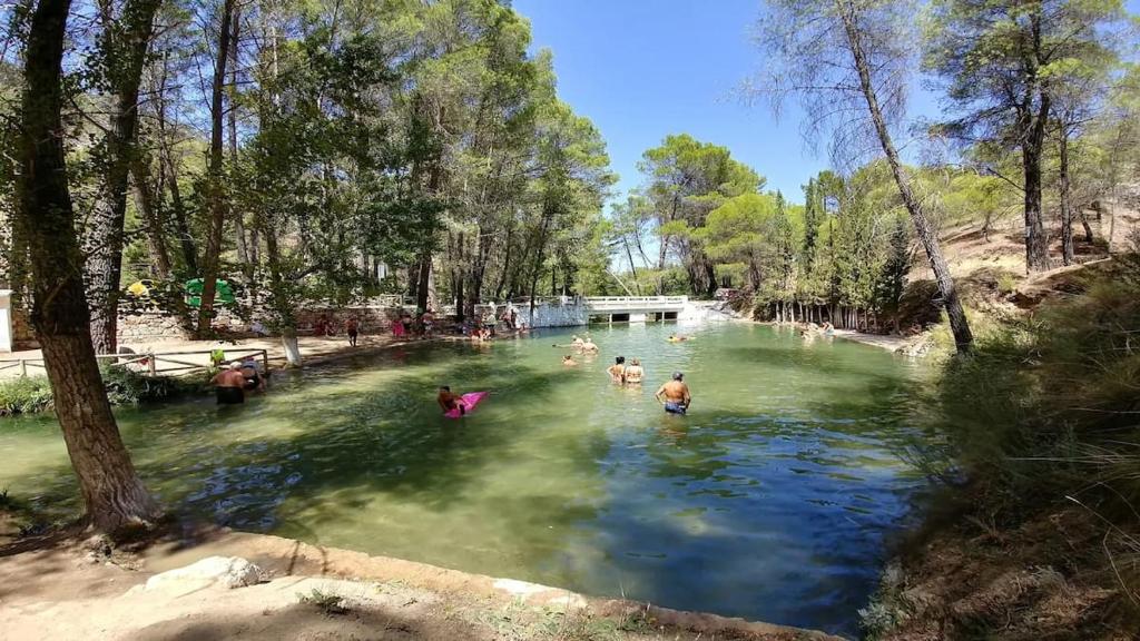 a group of people swimming in a river at Cortijo Mainacio in Siles