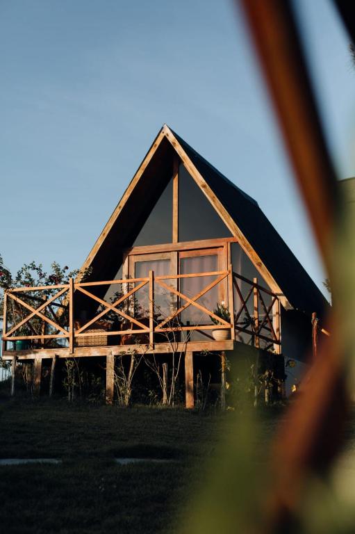 a house with a large window on the front of it at Cabanas Bouganville in Monte das Gameleiras